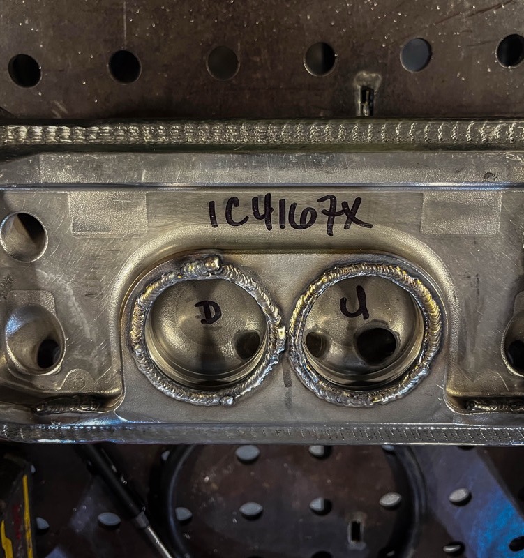 Marked-up bracket with welded bosses on a jig