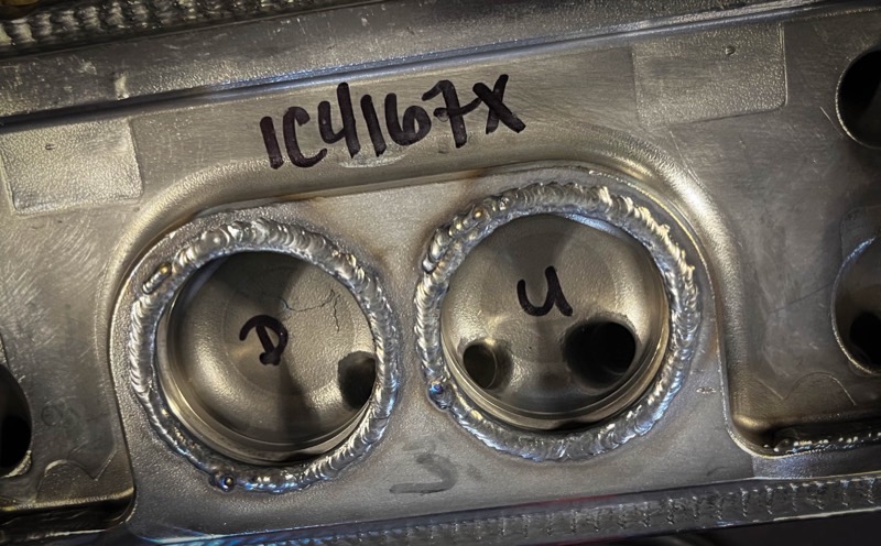 Close-up of welded bosses on a steel bracket
