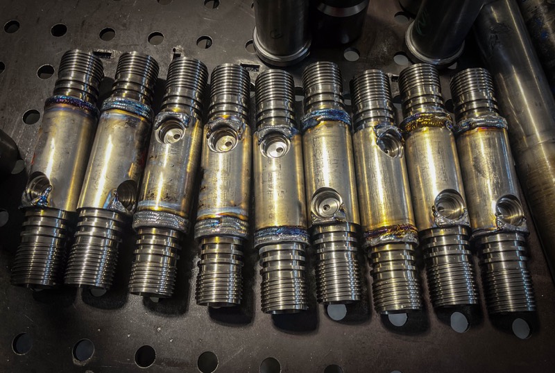 Welded drill stems lined up after fabrication