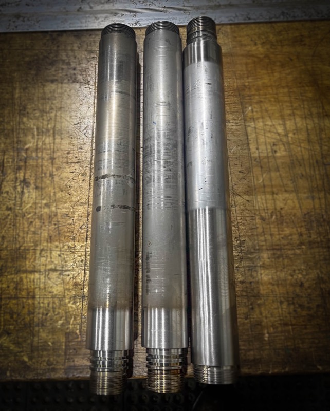 Three machined drill stems on the bench