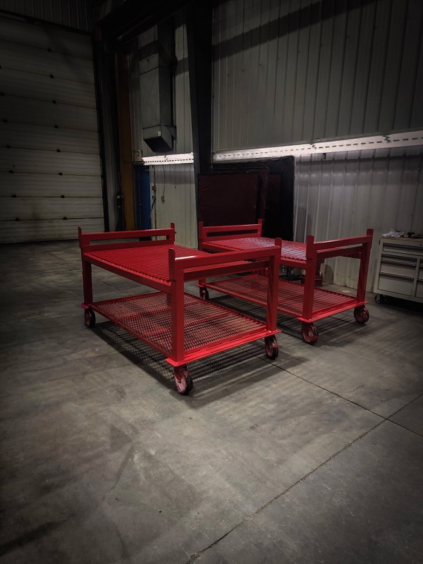 Two red flat-deck mobile carts