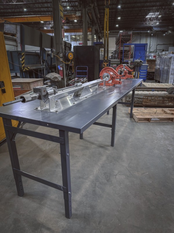 Custom pipe threading bench with vise tooling